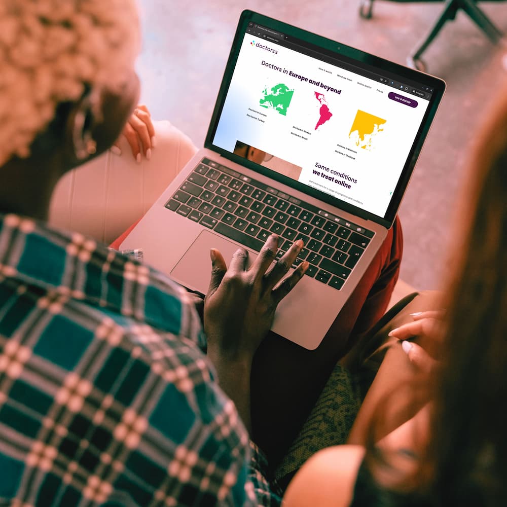 Two people using Doctorsa, an online platform to find an English-speaking UTI doctor in Istanbul, browsing available medical services across different regions on a laptop.