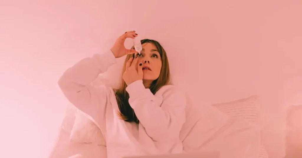 A woman applying eye drops, illustrating the treatment options for eye conditions such as pink eye vs stye.